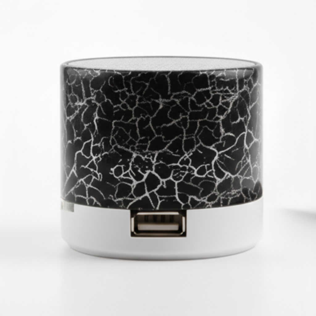 Small cylindrical device with cracked glass design next to a smartphone on a white background