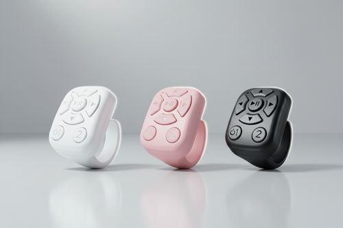 Three remote control-like devices in black, white, and pink on a gray background