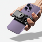 Hand holding a purple smartphone with a camera attachment on a white background